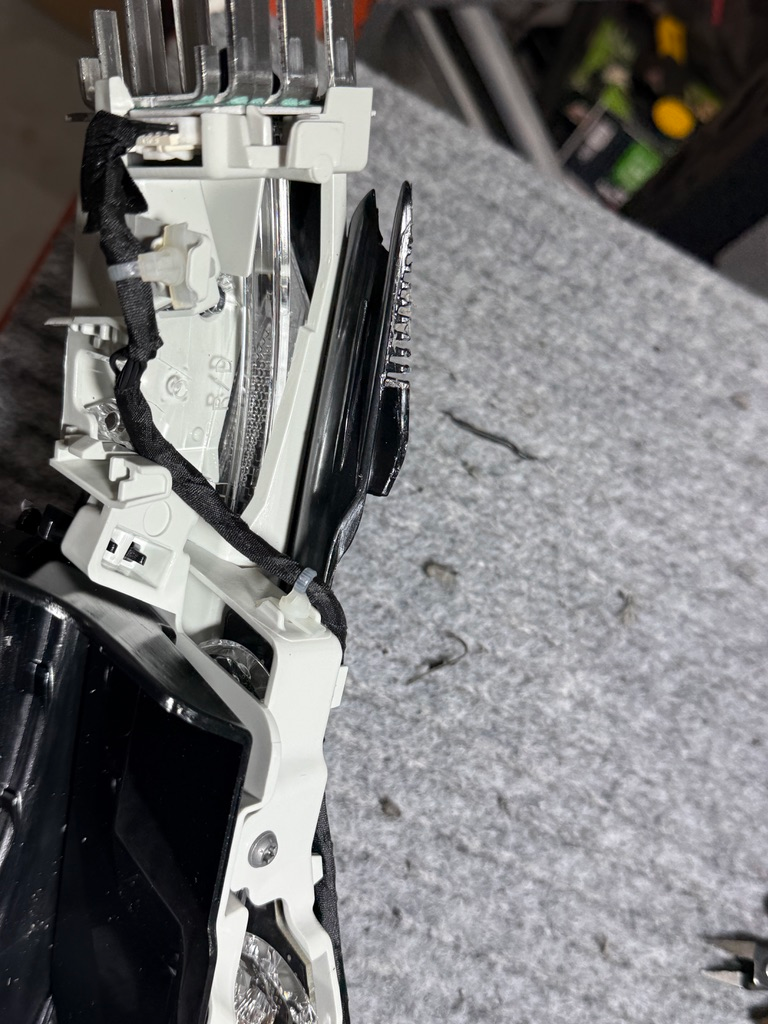 Inside the headlight housing.